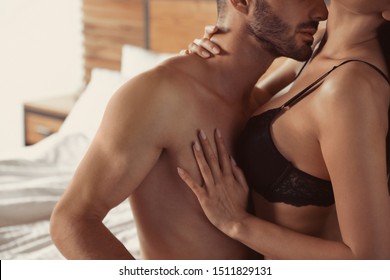 man kissing ladies boobs